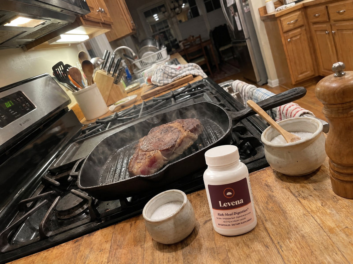 A ribeye on a grill pan, the Levena bottle on the counter
