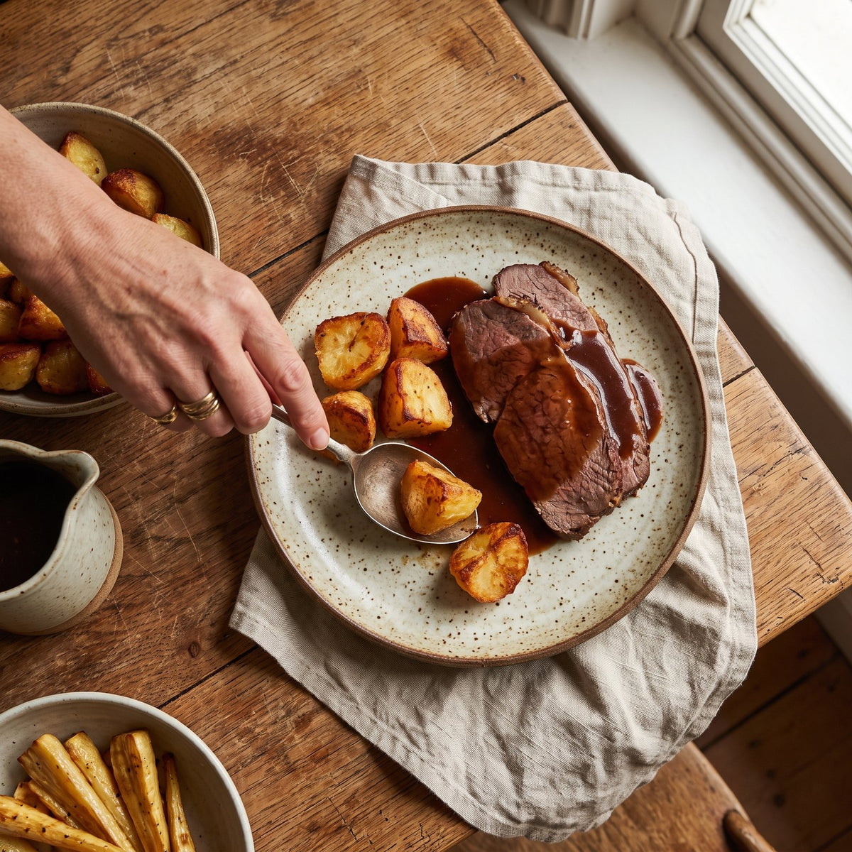 A Sunday roast plate with beef, potatoes and gravy